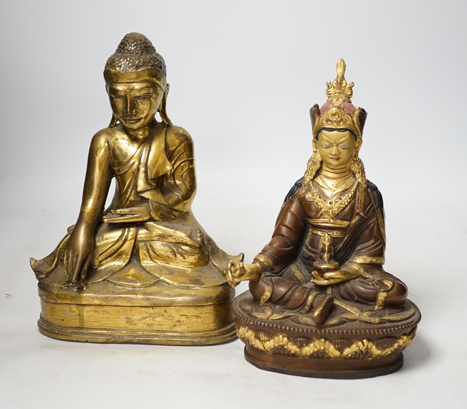 A Burmese bronze Buddha and a Nepalese bronze figure of Guru padmasambhava, tallest 23cm high. Condition - good